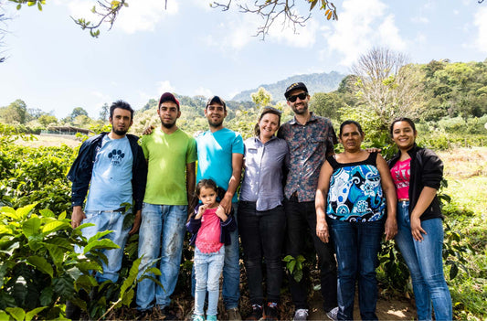 Dune Coffee owners at coffee farm location with farm owner and family