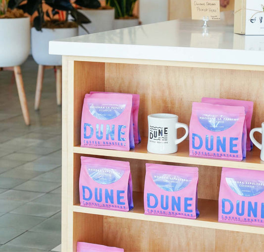Pink single origin coffee bags on shelf display