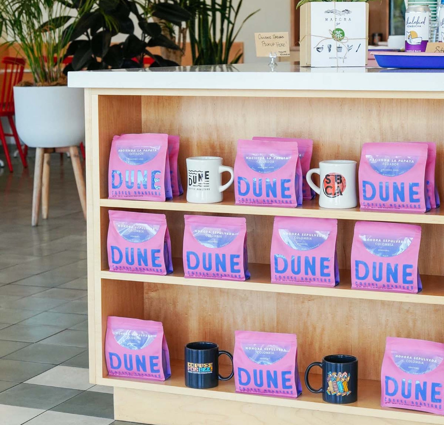 Array of pink single origin coffee bags on display